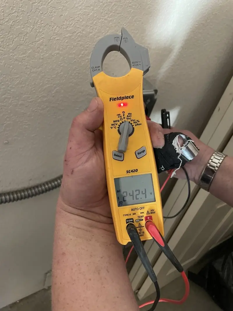 Voltage testing with clamp meter during Recessed Lighting Installation in Geneseo